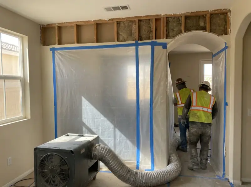 Plastic containment with a negative air machine and flood-cut drywall in Corona, California
