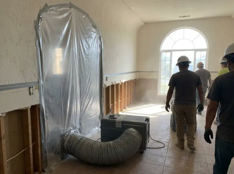 Plastic containment with a negative air machine and flood-cut drywall in San Diego, California