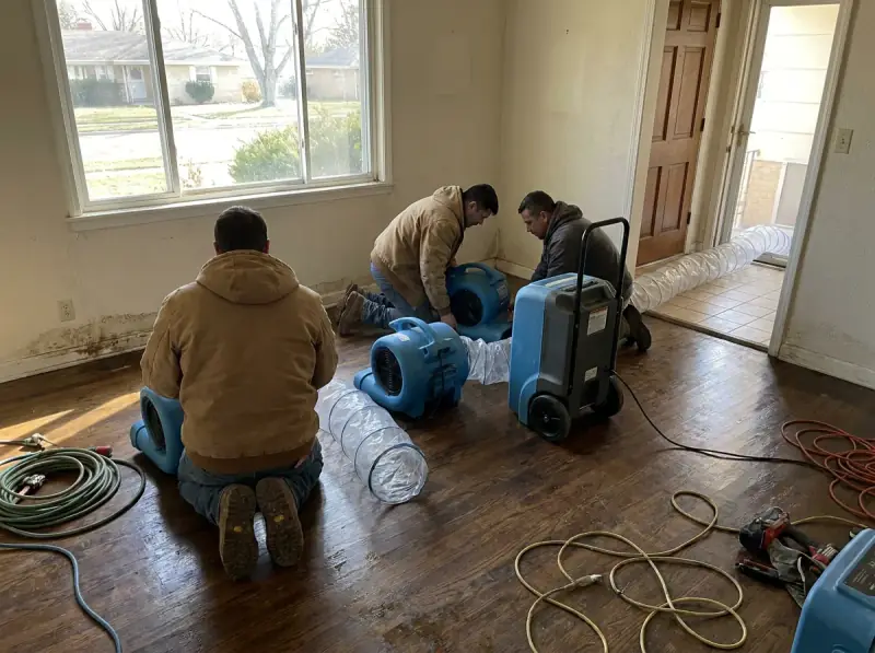 Commercial air movers and an LGR dehumidifier running on a wet floor in Santa Clara, California