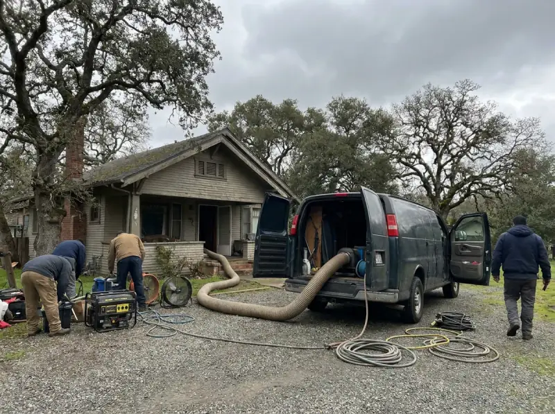 Restoration van staged with extraction hose run to the property in Santa Rosa, California